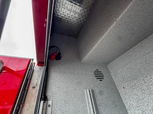 Rear upper side compartment open view with interior shelf.